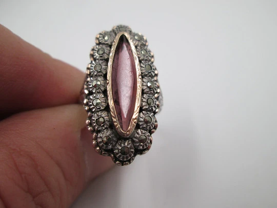 Women's shuttle ring. Silver and gold edge. Garnet stone & marcasite gems