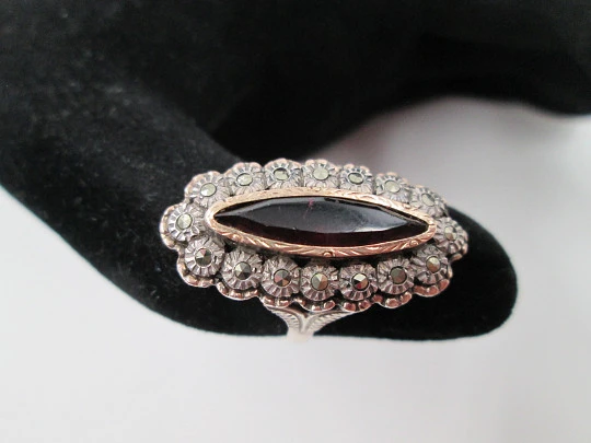 Women's shuttle ring. Silver and gold edge. Garnet stone & marcasite gems