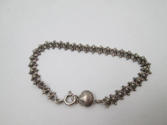 Women's sterling silver bracelet with sun motifs and shell pendant. Ring clasp. 1990's