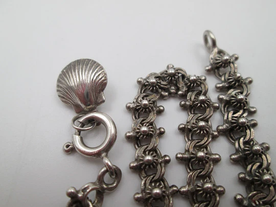 Women's sterling silver bracelet with sun motifs and shell pendant. Ring clasp. 1990's