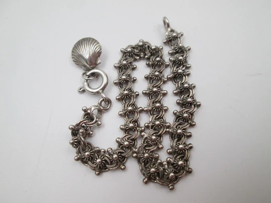 Women's sterling silver bracelet with sun motifs and shell pendant. Ring clasp. 1990's