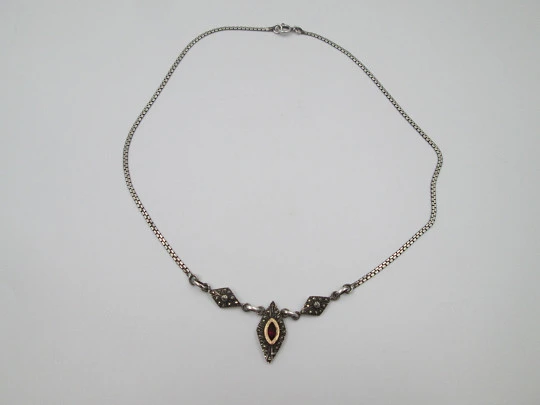 Women's sterling silver necklace and ring set. Marcasite stones, gold and garnet gems Women's sterling silver necklace and ring set. Marcasite stones, gold and garnet gems