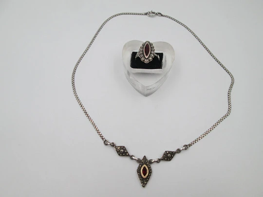 Women's sterling silver necklace and ring set. Marcasite stones, gold and garnet gems Women's sterling silver necklace and ring set. Marcasite stones, gold and garnet gems