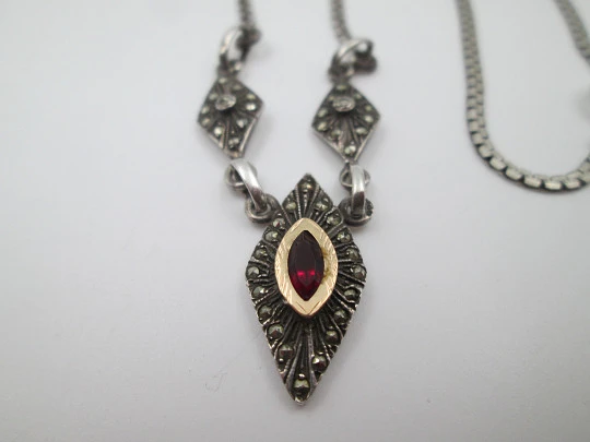 Women's sterling silver necklace and ring set. Marcasite stones, gold and garnet gems Women's sterling silver necklace and ring set. Marcasite stones, gold and garnet gems