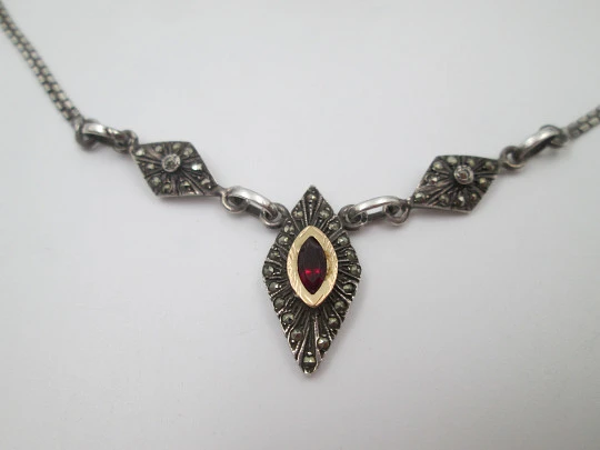 Women's sterling silver necklace and ring set. Marcasite stones, gold and garnet gems Women's sterling silver necklace and ring set. Marcasite stones, gold and garnet gems
