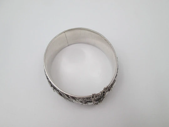 Women's wide bangle. Sterling silver. Elephants motifs on high relief. Europe. 1970's