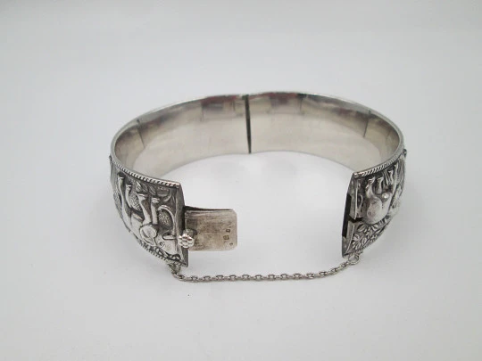 Women's wide bangle. Sterling silver. Elephants motifs on high relief. Europe. 1970's