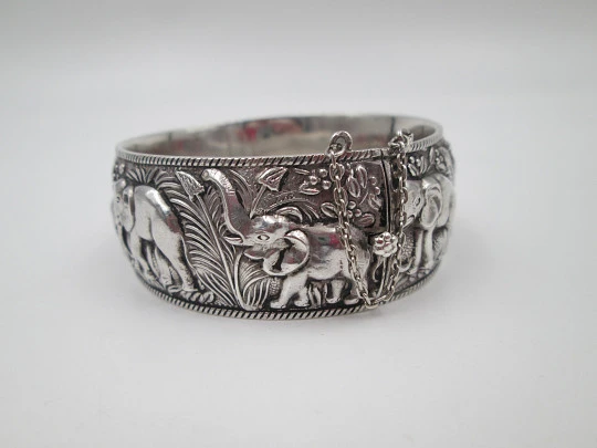 Women's wide bangle. Sterling silver. Elephants motifs on high relief. Europe. 1970's