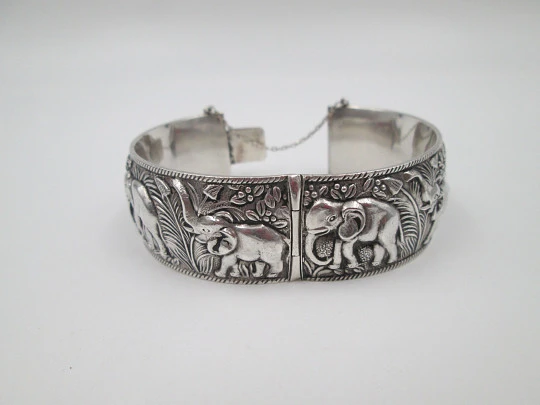 Women's wide bangle. Sterling silver. Elephants motifs on high relief. Europe. 1970's