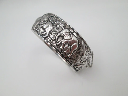 Women's wide bangle. Sterling silver. Elephants motifs on high relief. Europe. 1970's