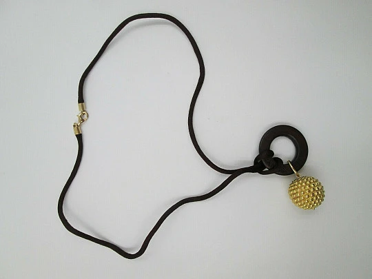 Yanes women's pendant. 18 karat yellow gold ball. Wood and silk cord