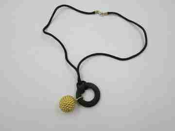 Yanes women's pendant. 18 karat yellow gold ball. Wood and silk cord