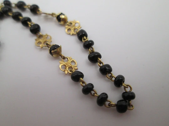 Yellow gold rosary and onyx beads. Openwork rosettes & crown. 1920's