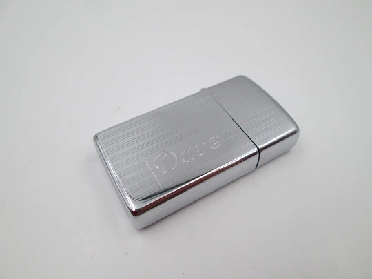 Zippo petrol pocket lighter. Chromed metal. Vertical lines pattern. United States. 1990's