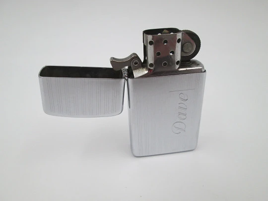 Zippo petrol pocket lighter. Chromed metal. Vertical lines pattern. United States. 1990's