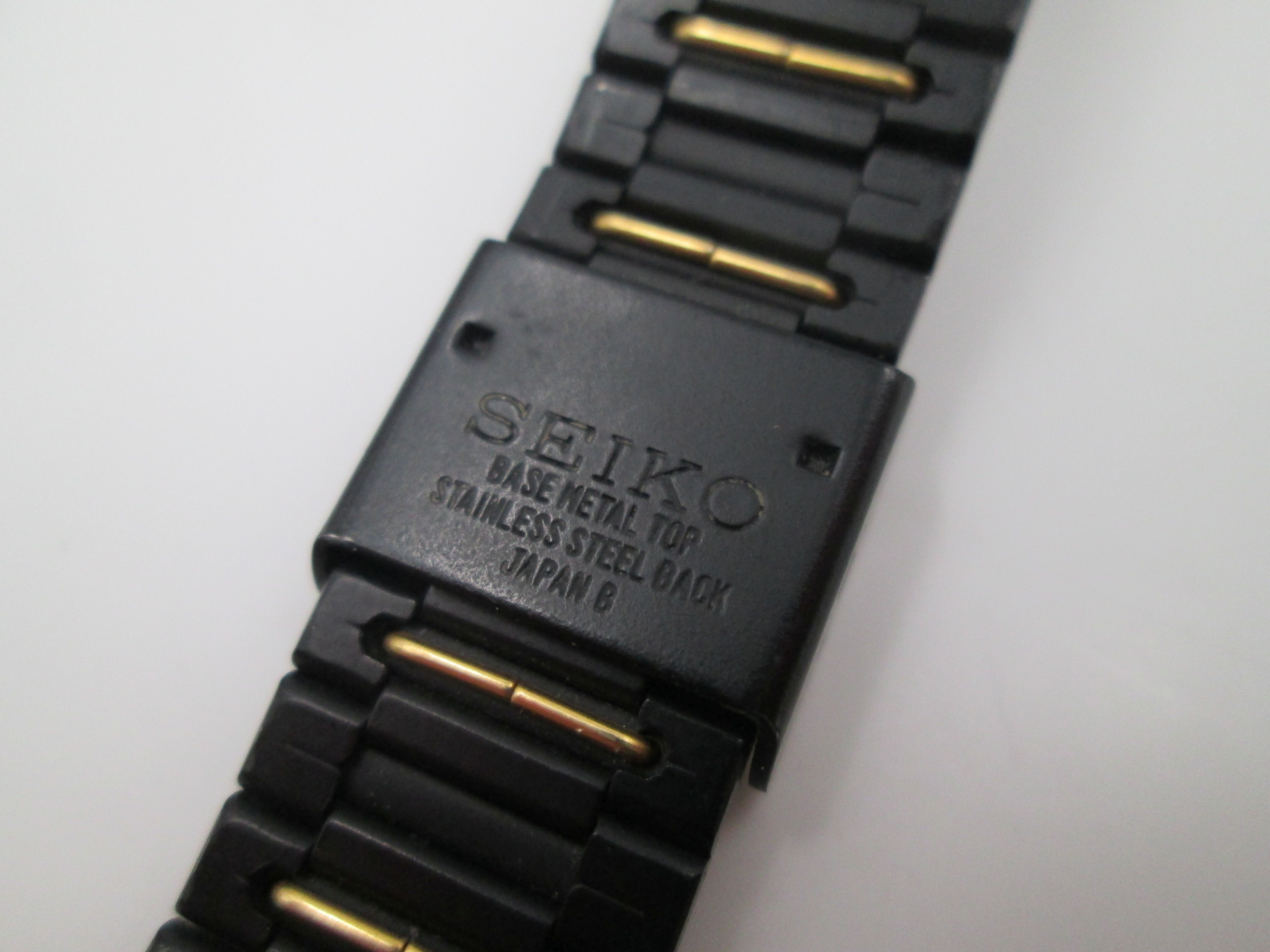 seiko black gold metal and steel quartz square case 1980s