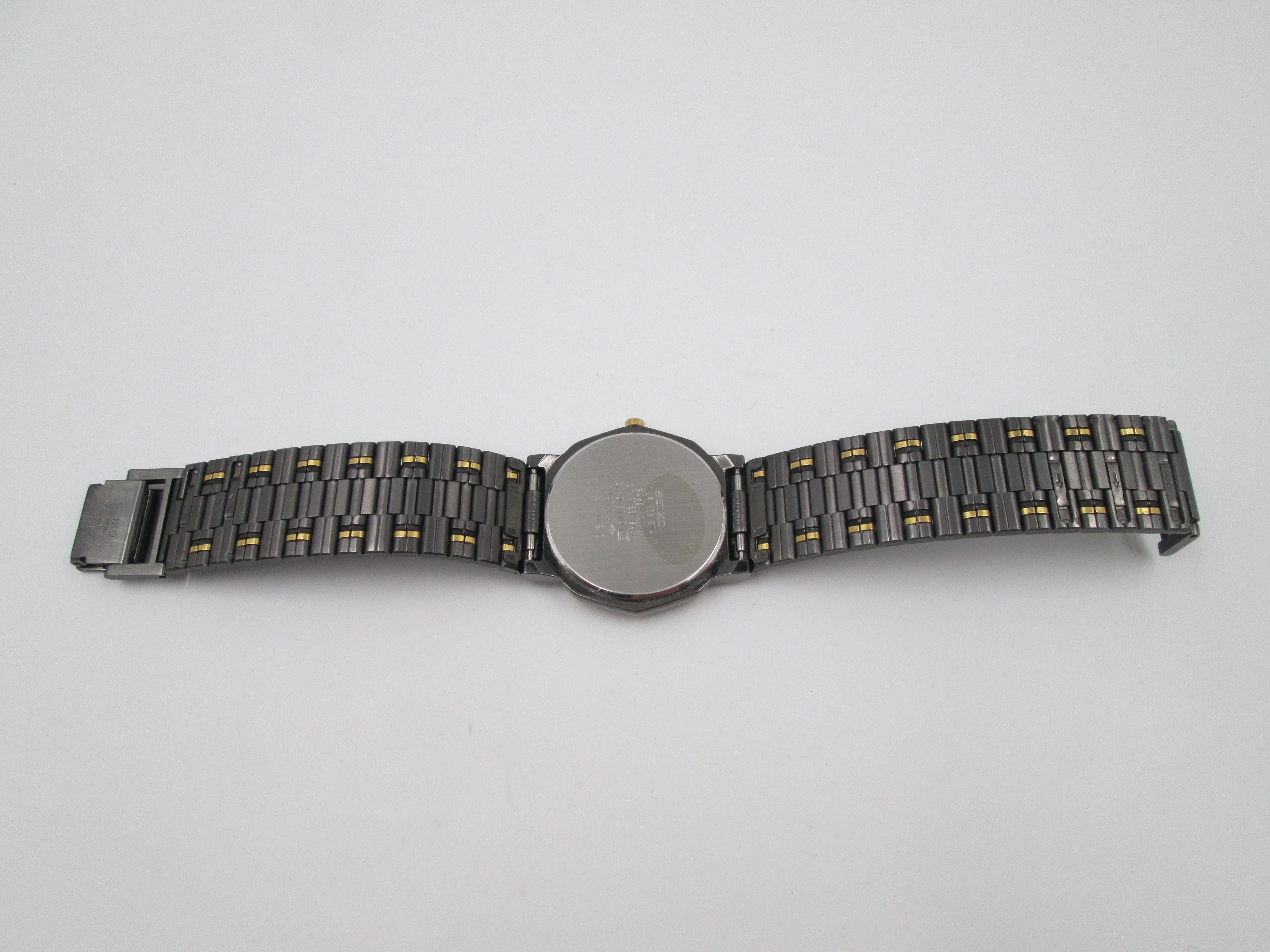 seiko black gold metal and steel quartz round case 1980s